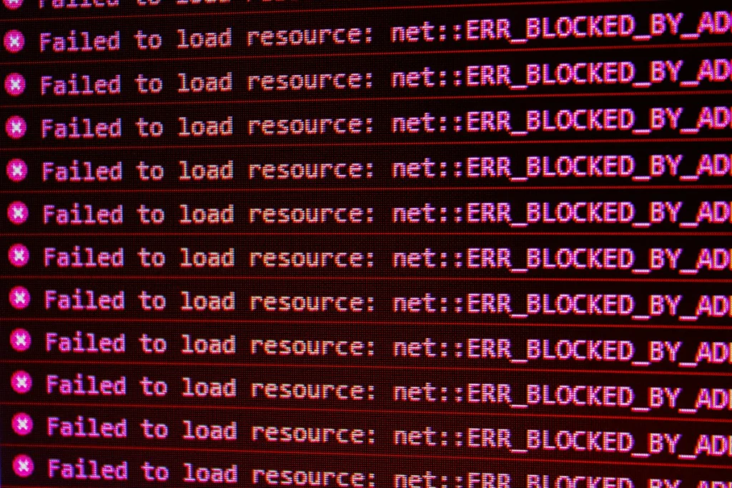 Red error messages on a black computer screen indicating blocked web resources